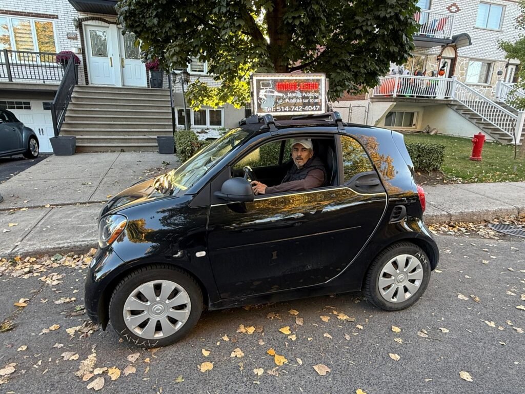 IMAGE-LEDiu founder operating a mobile LED advertising vehicle in Montreal, promoting creative street marketing.